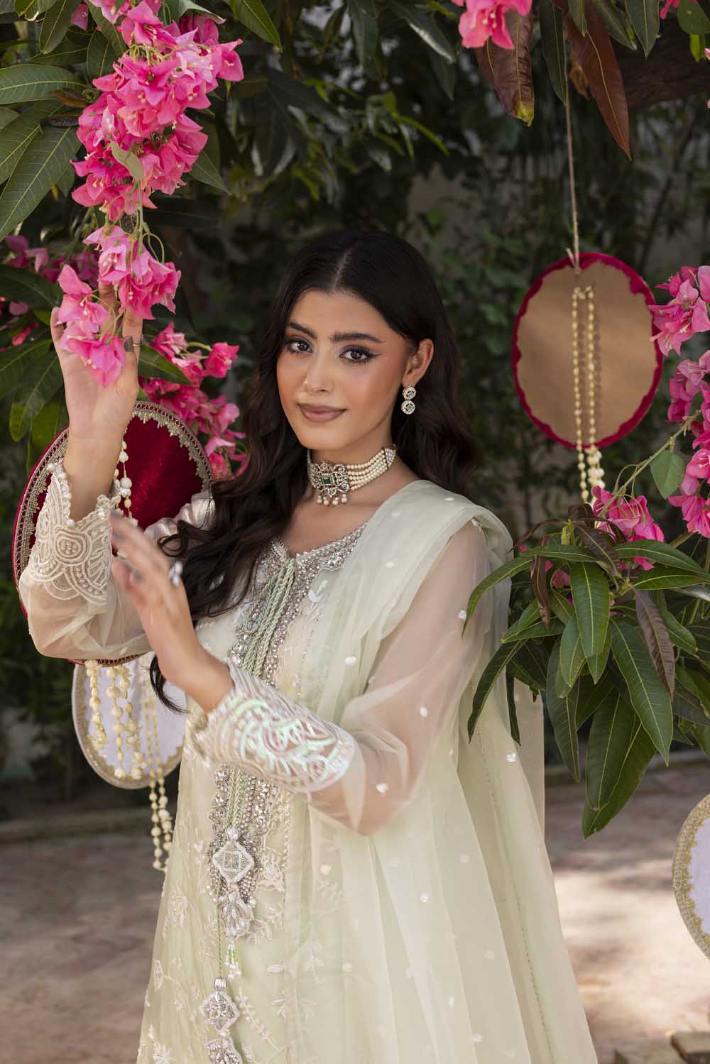 Woman in traditional outfit with floral decorations and jewelry