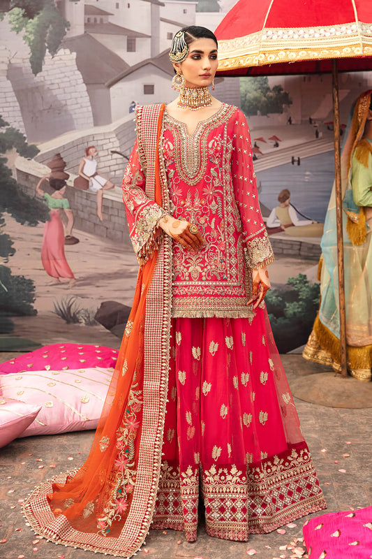Woman in traditional pink and orange embroidered outfit with a scenic background